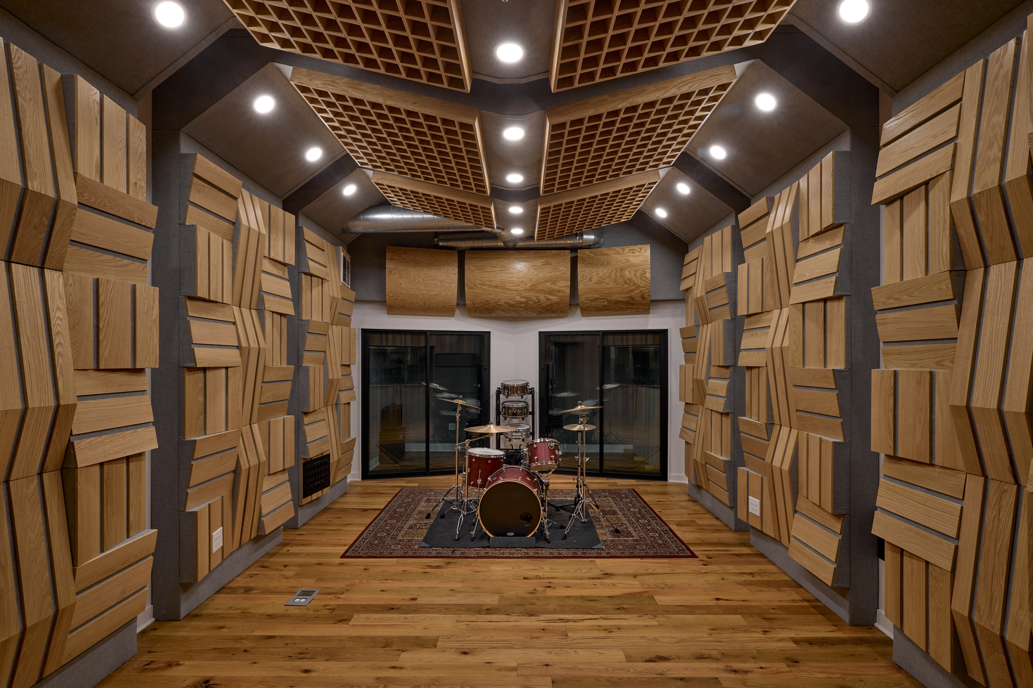 Live room with sound-proof walls and drumset.